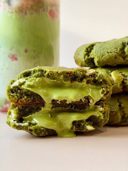 green matcha cookies with a cream filling on a light background