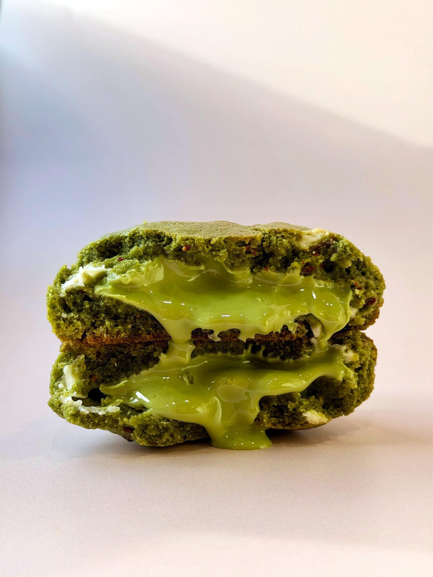 matcha green cookie with a matcha green filling on a white background